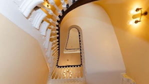 A staircase with a white railing and a decorative mirror at the top. - Opul Boutique (Douglas)