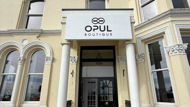 A building with a sign for 'OPUL BOUTIQUE' at the entrance. - Opul Boutique (Douglas)