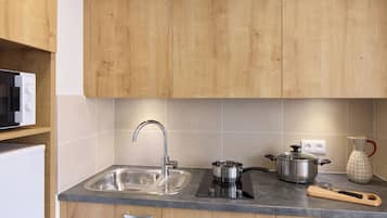 Mini-fridge, microwave, stovetop, cookware/dishes/utensils