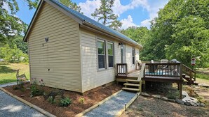 A single-story house with a front porch, a deck, and a small garden area. - Charming 1-bedroom country getaway in serene Salisbury (Salisbury)