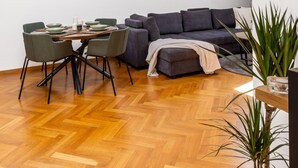 A modern loft with a dining area, a sofa, and a potted plant. - Cozy Luxe Home at the Heart of Old Prague Centre (Hlavní mesto Praha)