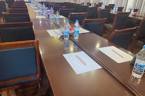 A conference room with long tables, chairs, and water bottles. - Forever Star Hotel (Fuyang)