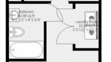 Plan d’étage d’une chambre d’hôtel comprenant une chambre à coucher de 12,74 mètres carrés, une salle de bain, une buanderie et une grande pièce à vivre de 33,48 mètres carrés.