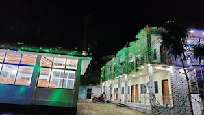 A building with multiple windows and balconies, surrounded by greenery. - Hotel Royal Beach & Restaurant (Saint Martin's Island)