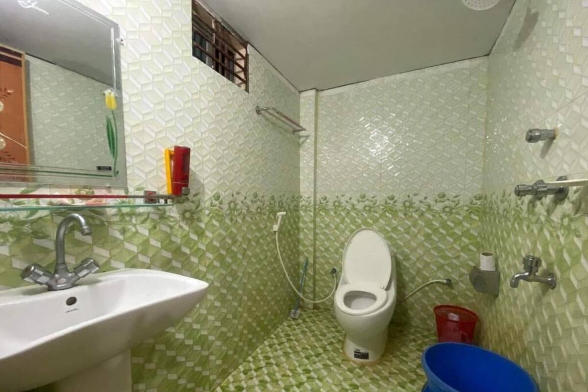 A bathroom with a sink, toilet, and shower area.