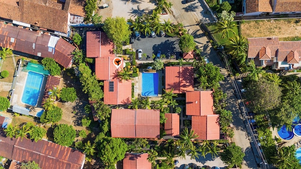 An aerial view of a resort with multiple buildings, swimming pools, and lush greenery. - Las Palmas 1BR+Loft w/ Pool—Walk to Beach & Dining (Coco)