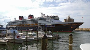 A large cruise ship docked at a marina with smaller boats nearby. - Family Escape | Oceanfront Condo + Pool Access (Cocoa Beach)