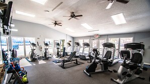 A gym with various exercise equipment, large windows, and ceiling fans. - Nature Escape w/ Resort Amenities, Sleeps 4 (Lake Lure)