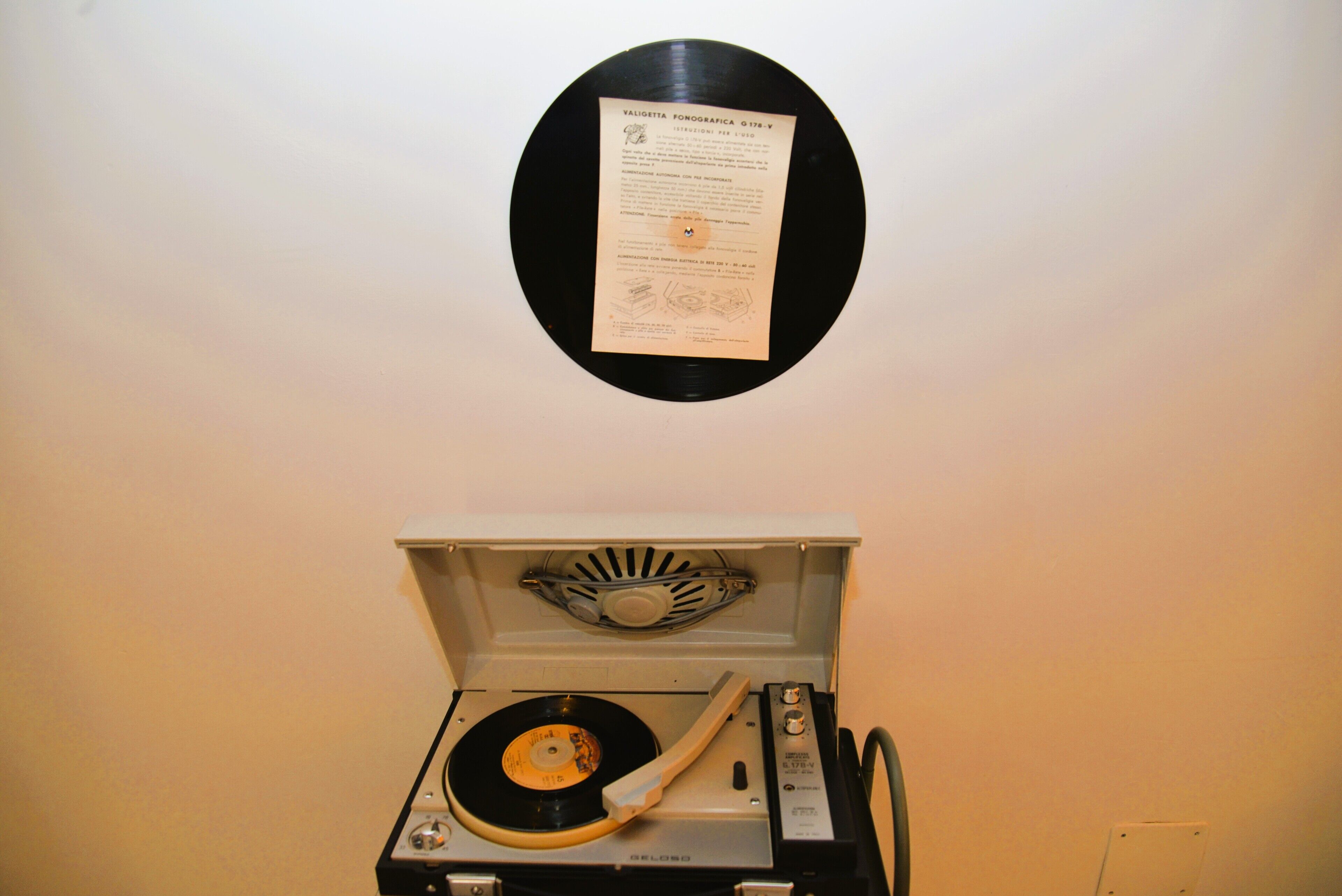 A turntable with a vinyl record and a record player.