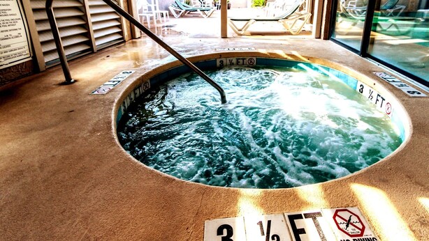 A hot tub with a depth marker of 3 1/2 feet and a no diving sign.