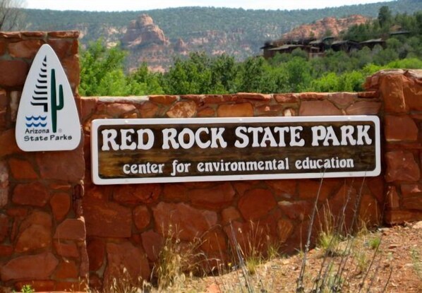 A sign for Red Rock State Park, indicating it is a center for environmental education.