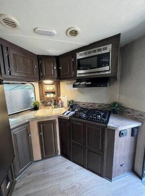 Fridge, microwave, stovetop, coffee/tea maker