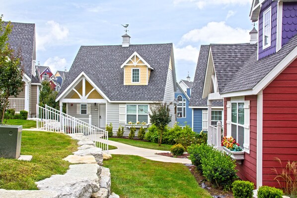 A residential neighborhood with houses featuring gabled roofs and front porches.