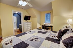 A bedroom with a bed, a desk, a chair, a TV, and a window. - 4-Bedroom Retreat near Silver Dollar City (Branson)