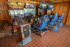 A room with arcade games, including 'Terminator Salvation' and 'Malibu'.