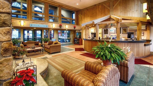A spacious lobby with a reception desk, seating area, and large windows. - Condo Nr Loon Mountain | King Bed + Balcony Views (Lincoln)