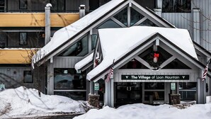 A building with a sign reading "The Village of Loon Mountain." - Spacious Loft Condo Near Loon Mountain (Lincoln)