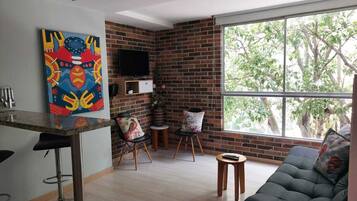 Standard Apartment | Living area | 40-inch Smart TV with cable channels