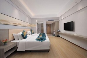 A modern hotel room with a large bed, a flat-screen TV, a bedside table, and a mirror on the wall. - Qingdao West Coast City Terrace Detai Hotel (Qingdao)