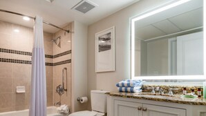 A bathroom with a bathtub, toilet, shower, and a vanity with a mirror. - Oceanfront Charming 2-bedroom hotel in delightful Myrtle Beach (Myrtle Beach)