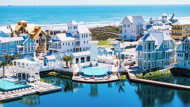 A coastal resort with multiple buildings, a central pool area, and a view of the ocean. - Once Upon a Beach 204 COA (Port Aransas)