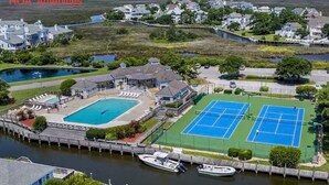 A coastal property with a swimming pool, tennis courts, and a dock with boats. - A Pirates Life - Fishing, Boat Slip, Pool, Gym!  (Manteo)