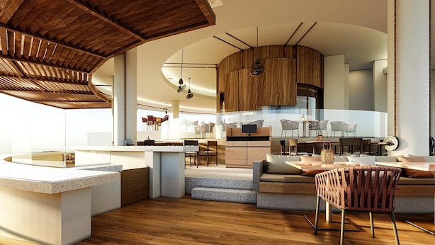 Een moderne keuken met houten kastjes, een centraal eiland en een eetgedeelte met een barkruk.