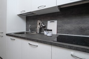 Fridge, dishwasher, coffee/tea maker, cookware/dishes/utensils