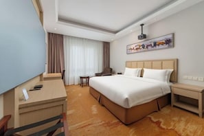 A hotel room with a large bed, a desk, a chair, a small table, and a TV. - Hangzhou Tong Huan Hotel (Hangzhou)