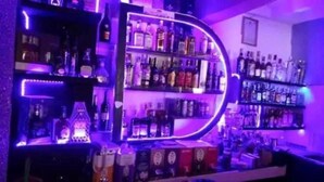 A bar area with shelves of liquor bottles and a neon sign. - Hotel Luna Nakuru (Nakuru)
