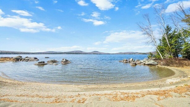 A lake with clear water, surrounded by rocks and trees. - New! Lakeview at Branch Lake (Ellsworth)