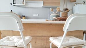 A kitchen with a wooden countertop, white chairs, and a sign that reads "WELCOME". - Eco Feng Shui Apartment with a View- Two Bedroom Apartment with Sea View (Tkon)