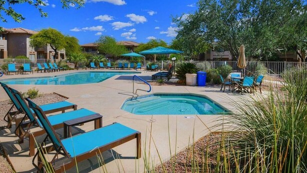 A pool area with lounge chairs, a hot tub, and umbrellas. - Welcome to Resort Casita (Oro Valley)