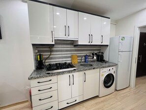 Fridge, stovetop, electric kettle, cookware/dishes/utensils