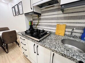Fridge, stovetop, electric kettle, cookware/dishes/utensils