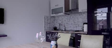 Enjoy meals and social gatherings in this well-equipped kitchen with a dining table and modern appliances.