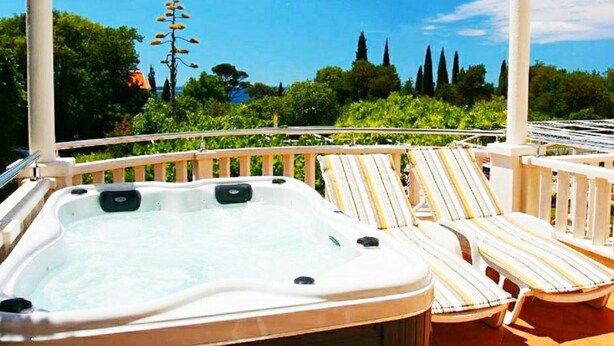 A hot tub with lounge chairs on a balcony with a view of trees and a clear sky. - Double Or Twin Room With Terrace and Sea View 10 (Mlini)