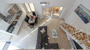 A modern interior with a dining area, sofa, and artwork. - Villa Shaula 2 - Three Bedroom House with Pool (Šibenik)