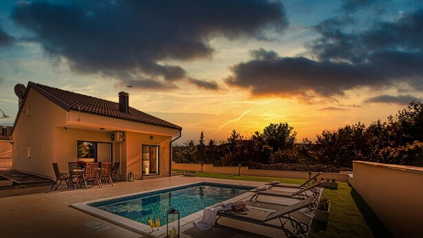 A modern house with a swimming pool, patio chairs, and a small bar area. - Villa Shaula 1 - Three Bedroom House with Pool (Šibenik)