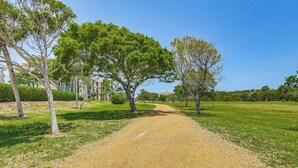 A gravel path in a park with trees and buildings in the background. - 1/2 Mi to Jupiter Beach: Penthouse Condo w/ Views (Jupiter)