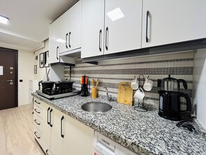 Fridge, stovetop, electric kettle, cookware/dishes/utensils