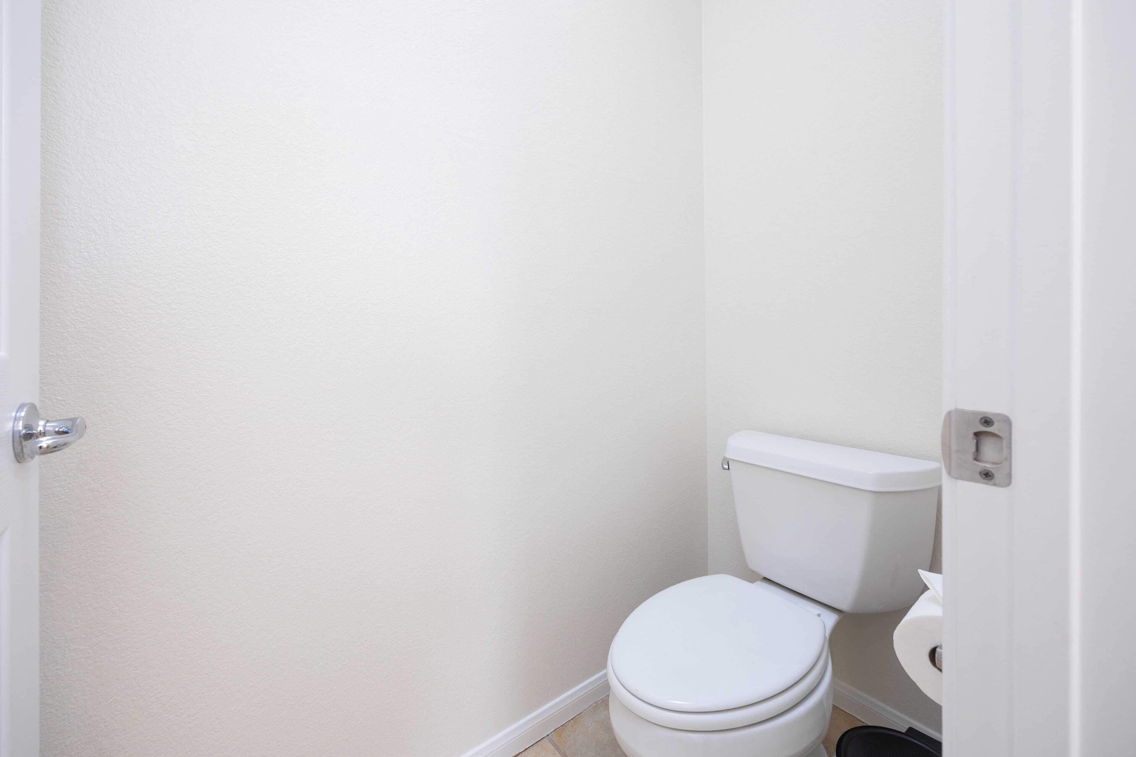 A small, clean bathroom with a white toilet and a white sink.