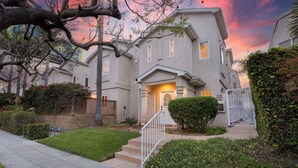 A two-story residential building with a front entrance, a small front yard, and a gated driveway. - Walk to Dining, Mission + Pacific Beach, and Bars/nightlife Private Backyard (San Diego)