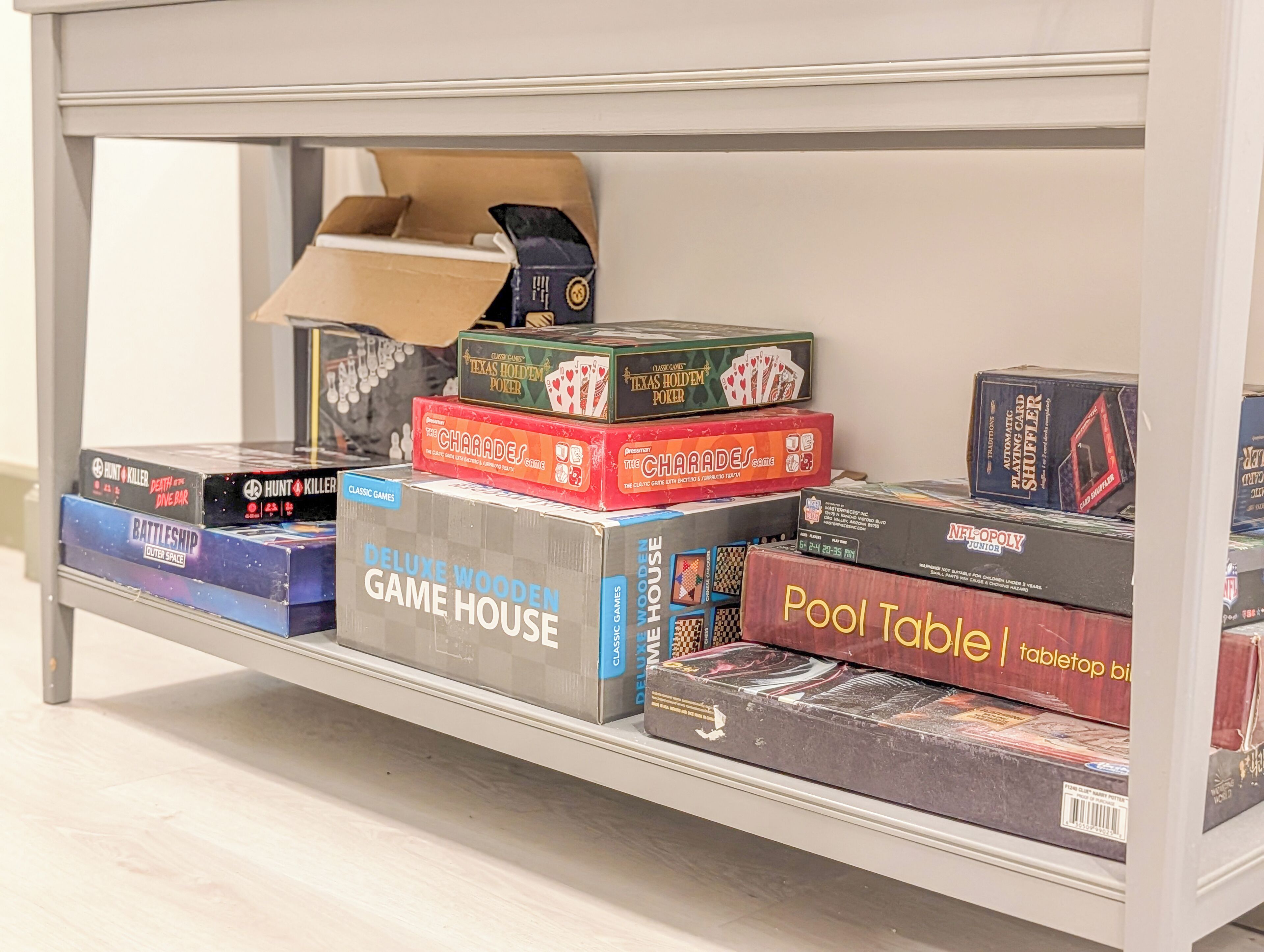 A shelf with various board games and card games.