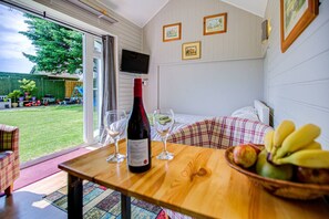 Enjoy a meal at the dining table, relax in the seating area, or take in the serene garden view from the large window.