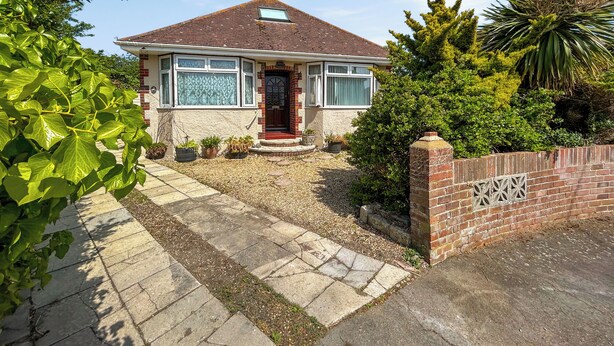 A single-story house with a tiled roof, a front porch, and a brick entrance. - 3 bedroom accommodation in Weymouth (Weymouth)