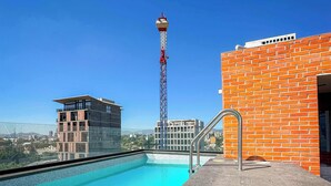A rooftop pool with a clear view of the cityscape, including a tall communication tower and modern buildings. - Modern stay in Colonia Americana (Guadalajara)