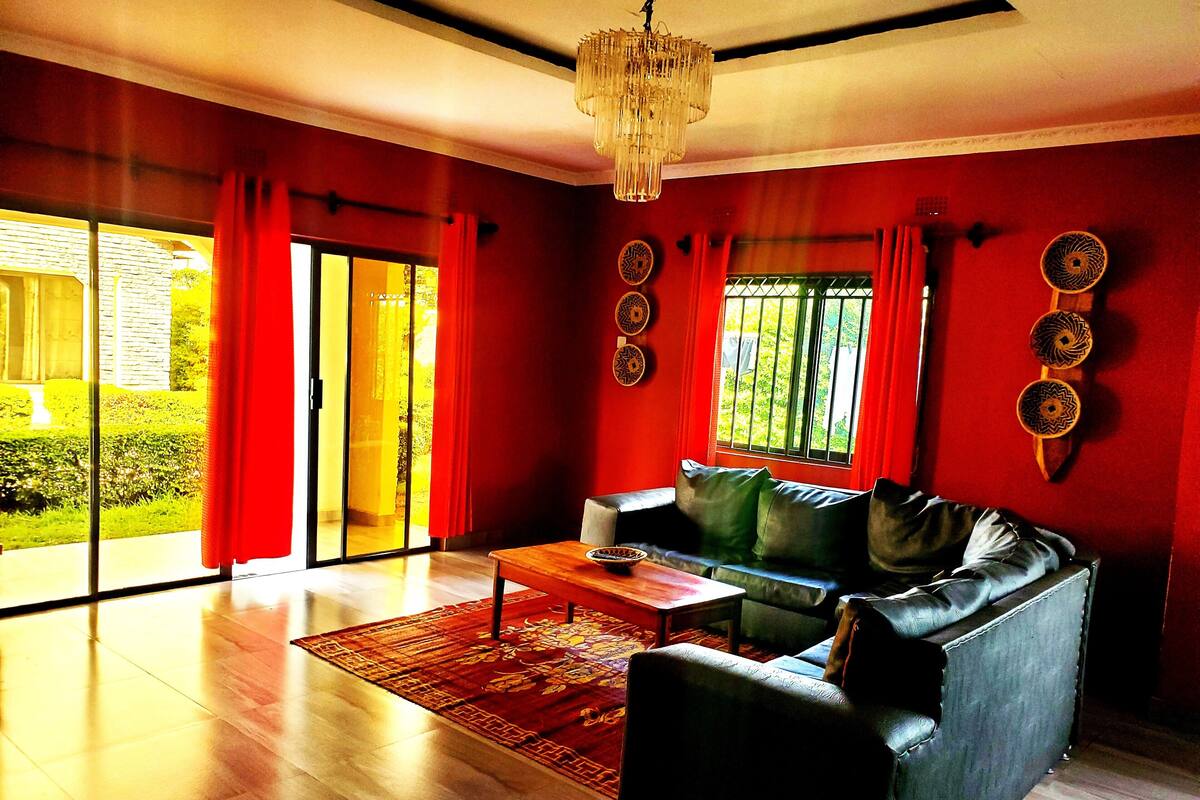 A living room with a sofa, a coffee table, and a chandelier.