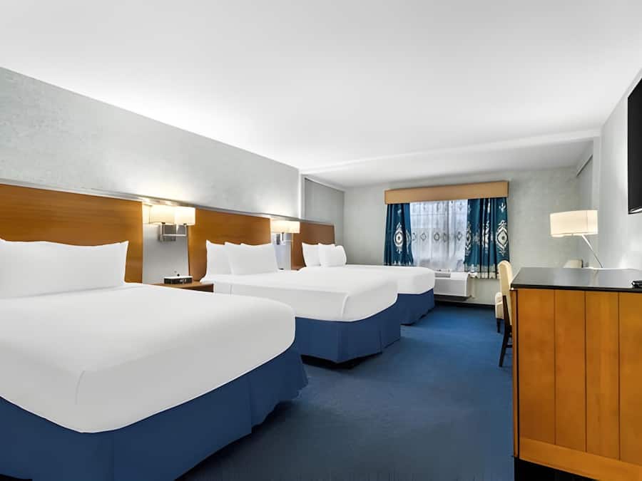 Premium bedding, desk, laptop workspace, blackout curtains