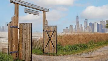 A wooden gate with a sign reading 'Collective Retreats' and a city skyline in the background.
